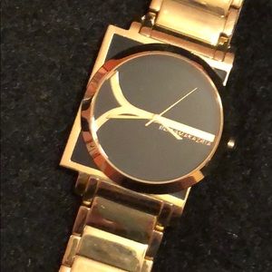 BCBGMAAXARIA gold watch. Black face.